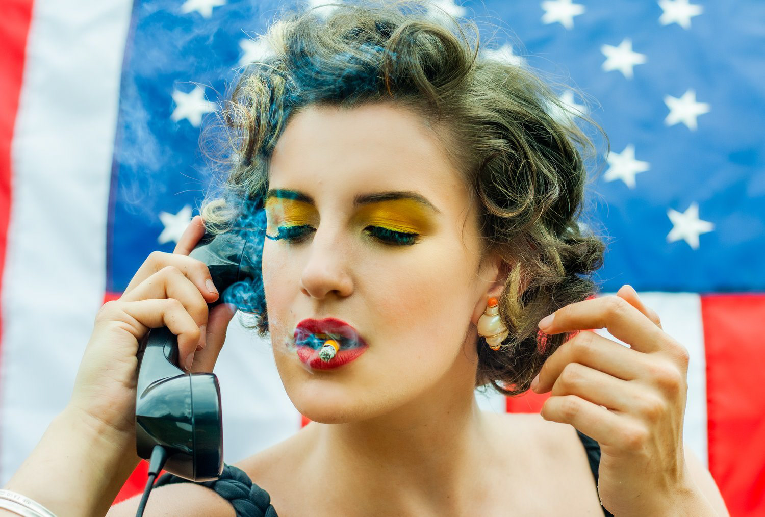 Alanna Mahon photography — portrait with colorful eye makeup against an American flag
